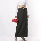 White cropped silk shirt with wrap-around tie detail and long sleeves styled with black skirt — Christopher Esber | Endless UAE