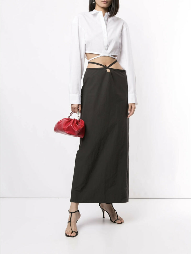 White cropped silk shirt with wrap-around tie detail and long sleeves styled with black skirt — Christopher Esber | Endless UAE