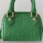 Green crocodile-embossed mini tote bag with gold hardware held by hand — By Far | Endless UAE