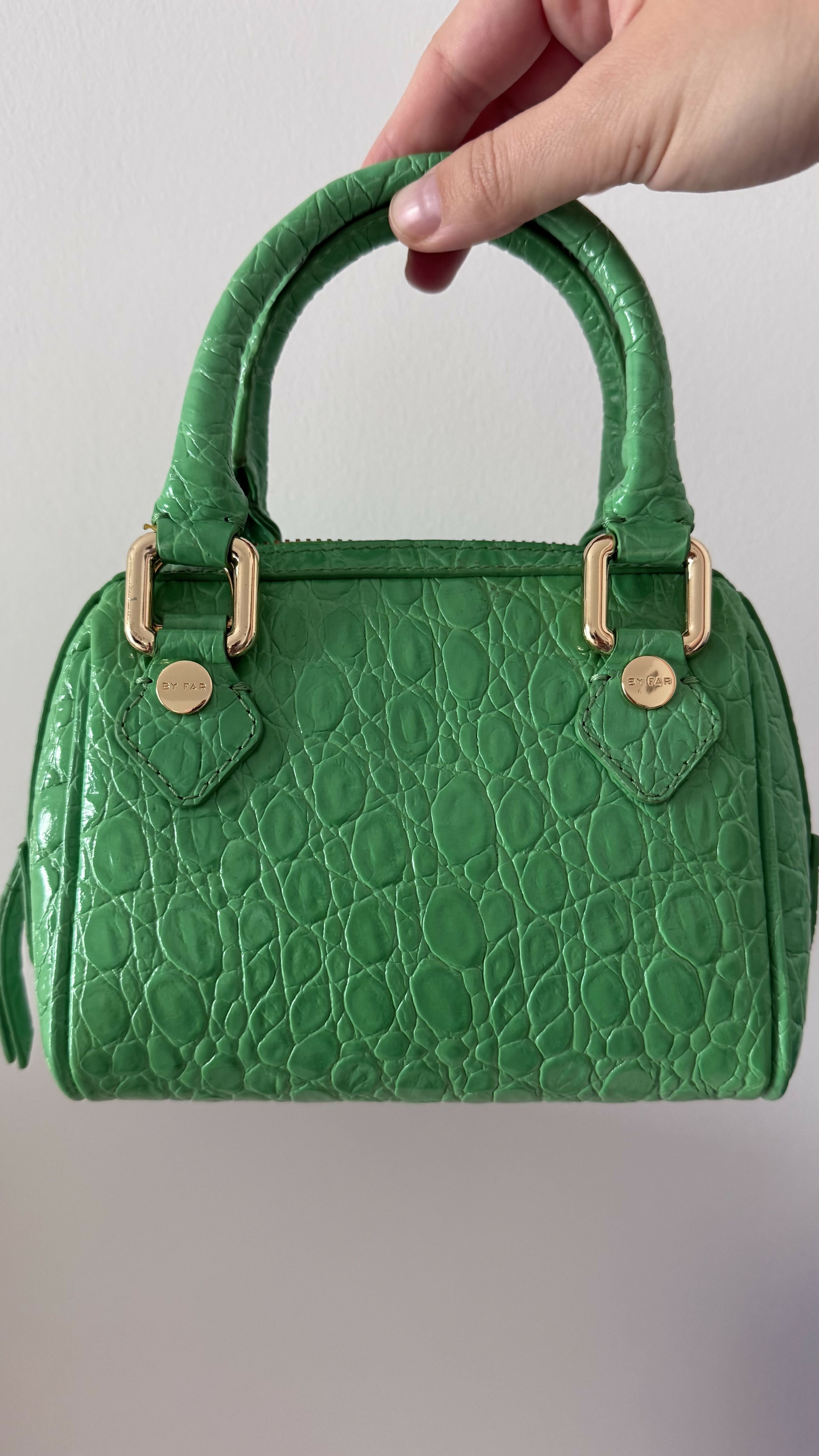 Green crocodile-embossed mini tote bag with gold hardware held by hand — By Far | Endless UAE