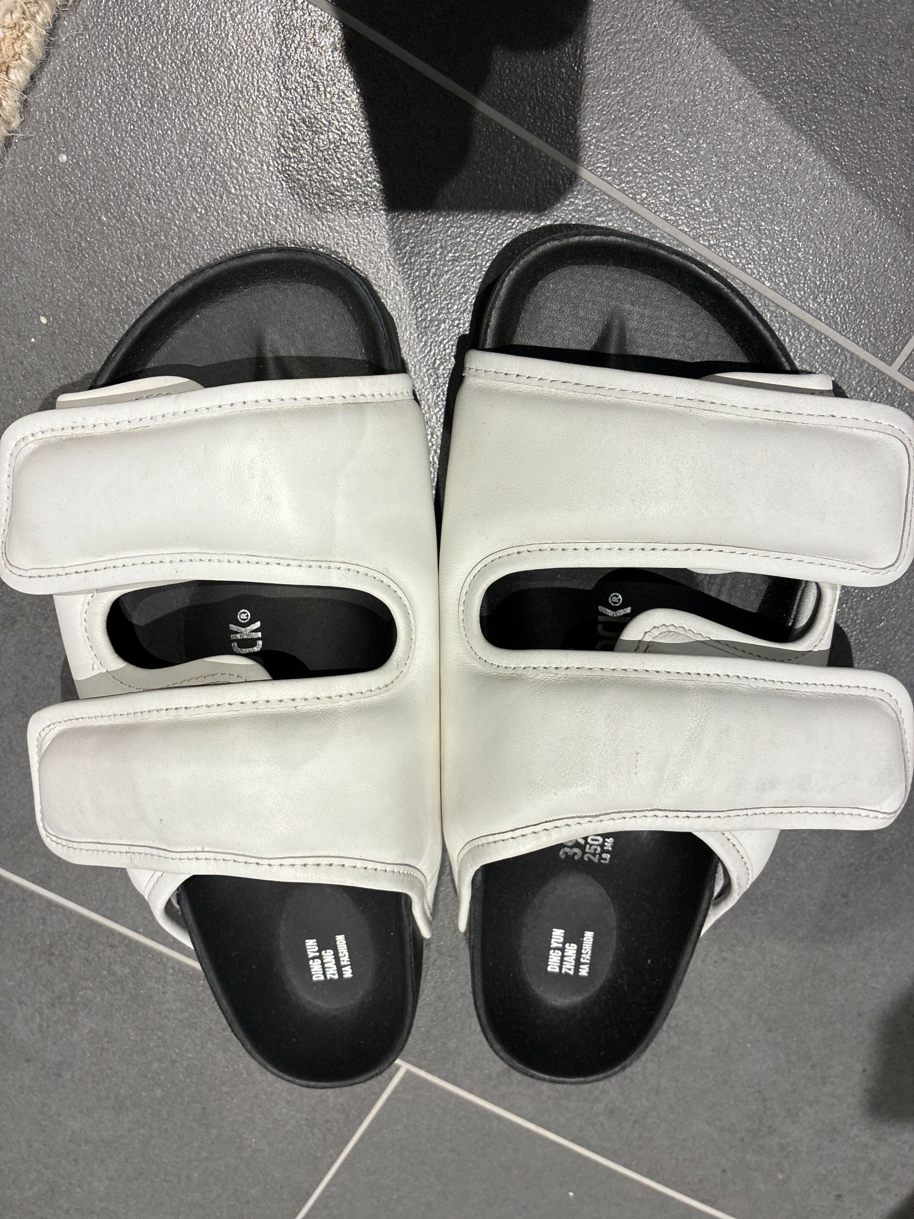 White leather CSM Cosy sandals with black footbed and dual strap design viewed from above — 1774 Birkenstock | Endless UAE