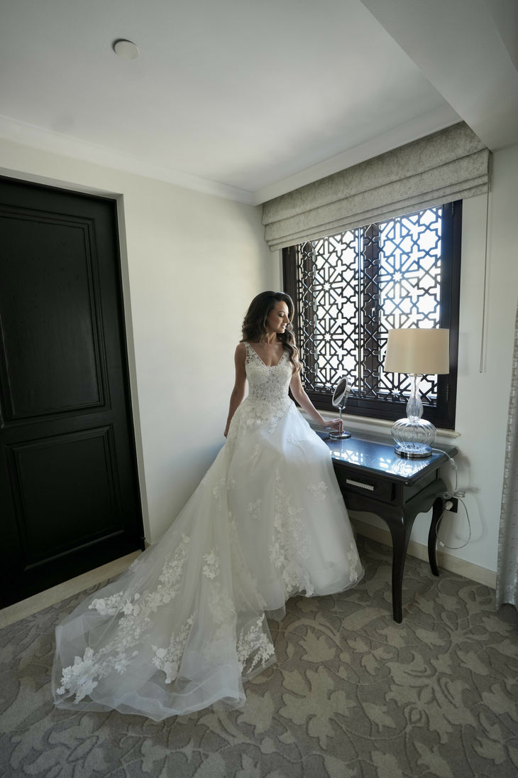 Elegant bride in a white lace ball gown wedding dress with V-neckline and cathedral train in luxurious suite — Rosa Clara | Endless UAE