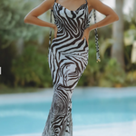 Woman wearing black and white zebra print maxi dress by pool — Endless | Endless UAE