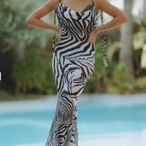 Woman wearing black and white zebra print maxi dress by pool — Endless | Endless UAE