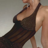Blonde woman wearing black sparkle embellished corset with sheer mesh panel and crystal drop earrings — Endless | Endless UAE