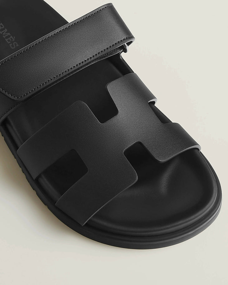 Black leather Chypre sandal with iconic H-cut design and adjustable ankle strap — Hermes | Endless UAE