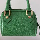 Green crocodile-embossed mini tote bag with gold hardware held by hand — By Far | Endless UAE