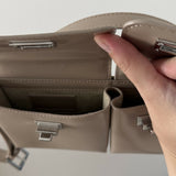 Beige patent leather shoulder bag with dual compartments and silver turnlock closures — Endless | Endless UAE