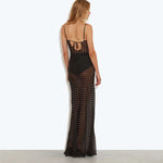 Back view of woman wearing black sheer polka dot maxi dress with tie detail and spaghetti straps — Rat & Boa | Endless UAE