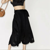 Black linen cropped top with ruffle neck detail and tie straps, paired with matching midi skirt — Zimmermann | Endless UAE