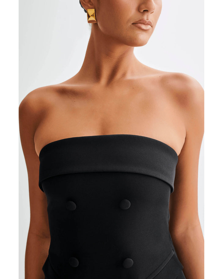 Black strapless mini dress with fold-over bodice and button details, worn by model showing upper body and torso — Meshki | Endless UAE