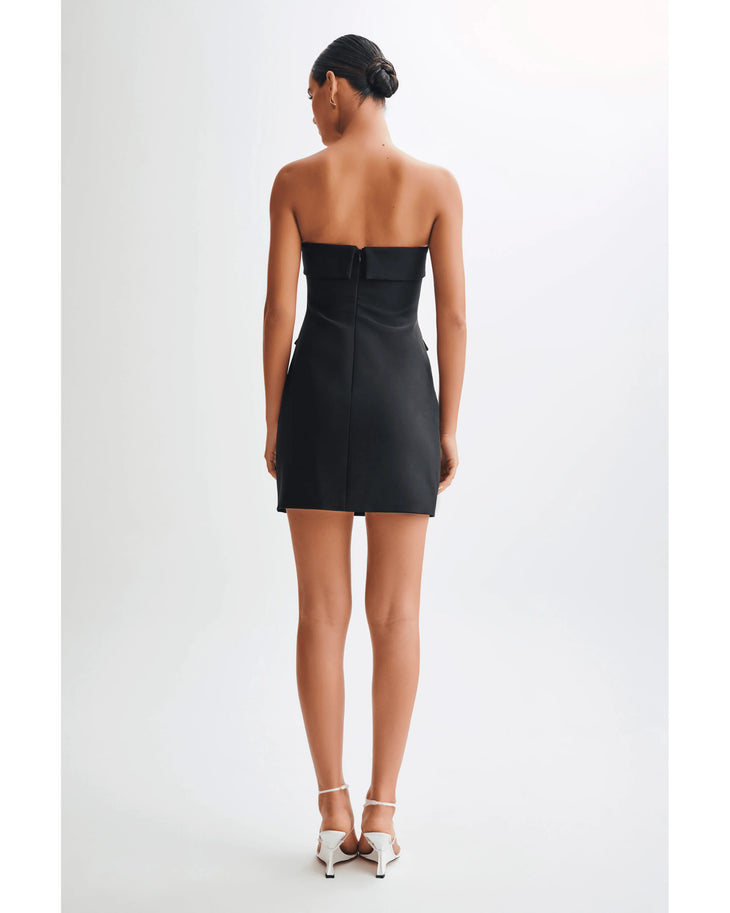 Black strapless fitted mini dress with structured silhouette, back view on model wearing white heels — Meshki | Endless UAE
