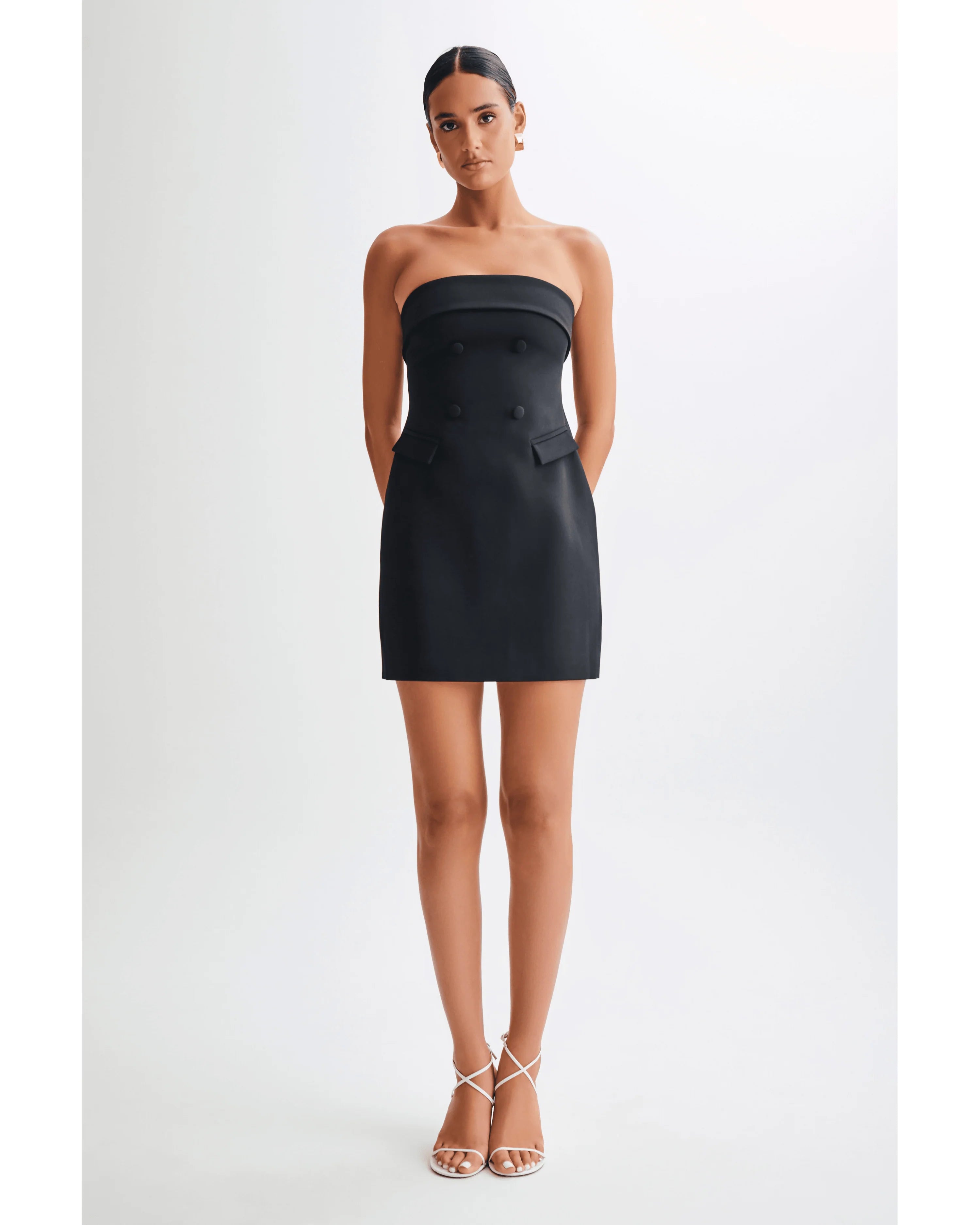 Black strapless mini dress with double-breasted button detail and side pocket accent — Meshki | Endless UAE