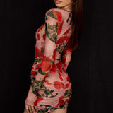 Woman wearing rose print corset mini dress with long sleeves and ruched detailing on black background — House of CB | Endless UAE