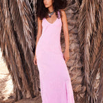 Woman wearing pink sleeveless maxi dress standing between dried palm fronds — Rat & Boa | Endless UAE