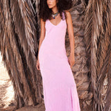 Woman wearing pink sleeveless maxi dress standing between dried palm fronds — Rat & Boa | Endless UAE