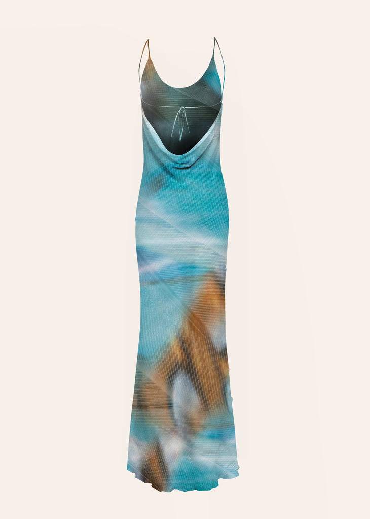 Woman wearing blue tie-dye maxi dress standing on rocky beach — Dvete | Endless UAE