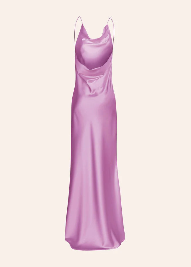 Woman wearing a pink satin slip dress with thin straps and flowing maxi length — Dvete | Endless UAE