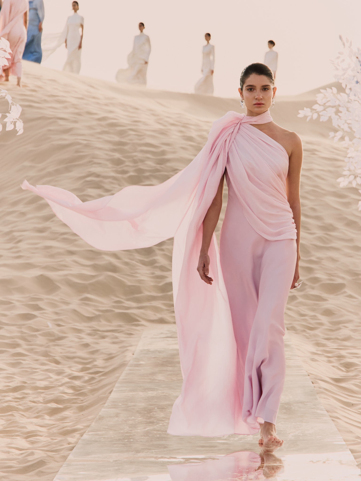 Woman wearing pink textured maxi dress in desert setting — Lichi | Endless UAE