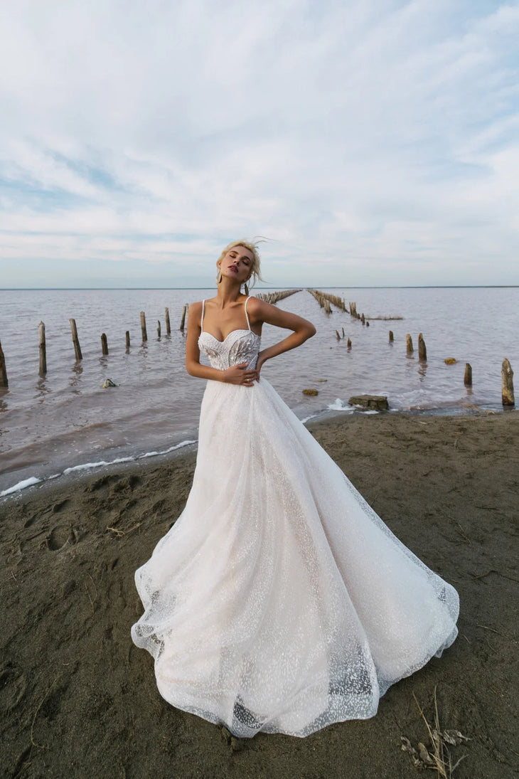 Flowing A-line wedding dress with lace bodice and sparkle tulle skirt on beach — Romanova Atelier | Endless UAE
