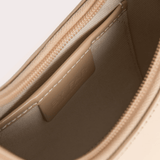 Interior view of Baby Amber semi patent mini leather handbag showing beige lining and card slot — By Far | Endless UAE