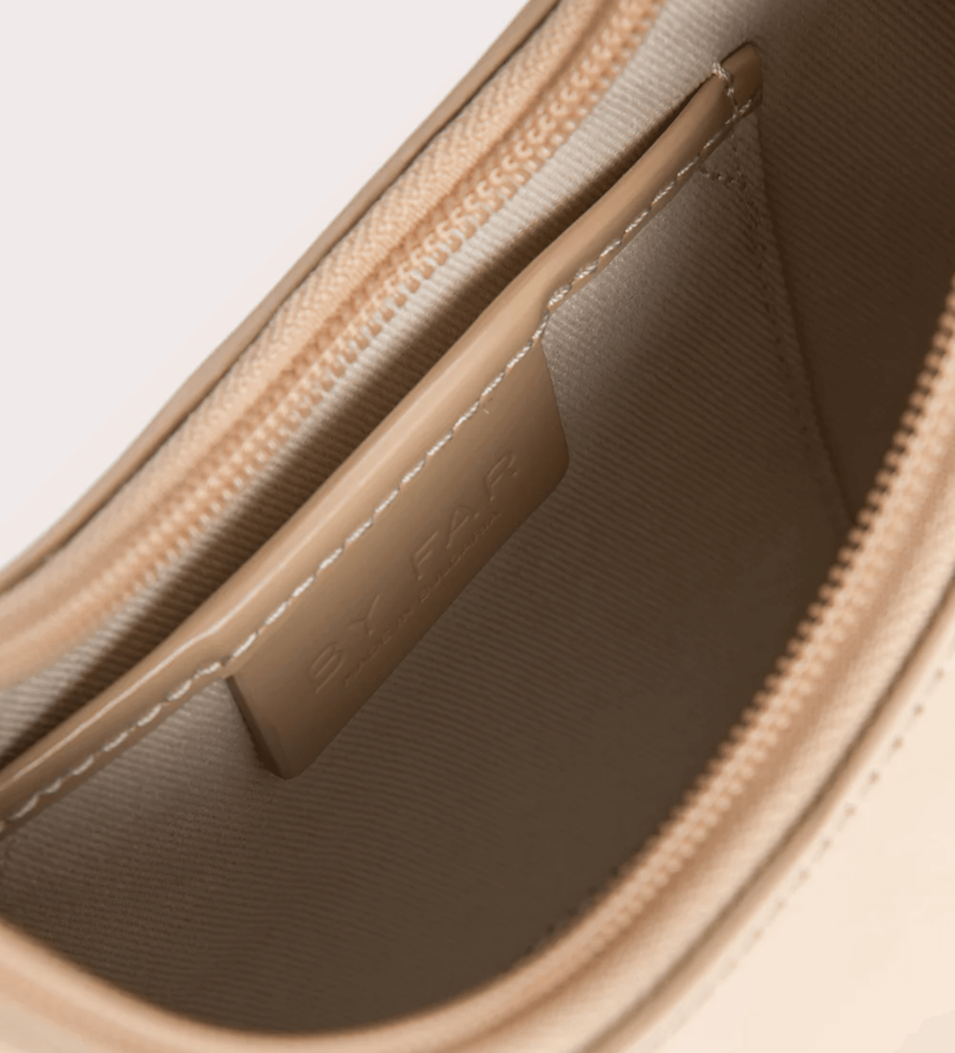 Interior view of Baby Amber semi patent mini leather handbag showing beige lining and card slot — By Far | Endless UAE