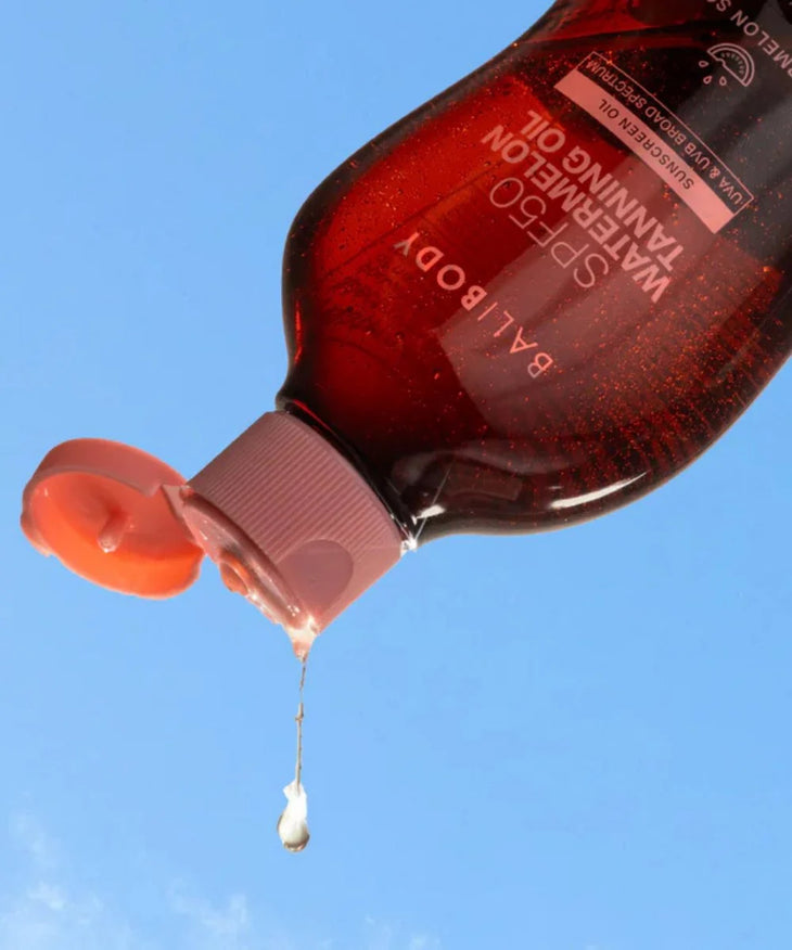 Bali Body SPF50 Watermelon Tanning Oil in amber bottle with pink cap — Powder Beauty | Endless UAE