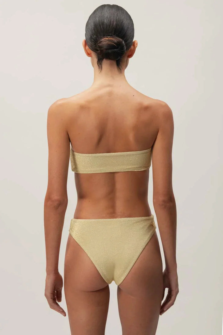 Rear view of gold metallic Tali strapless bandeau bikini set with high-cut bottoms — Baobab | Endless UAE