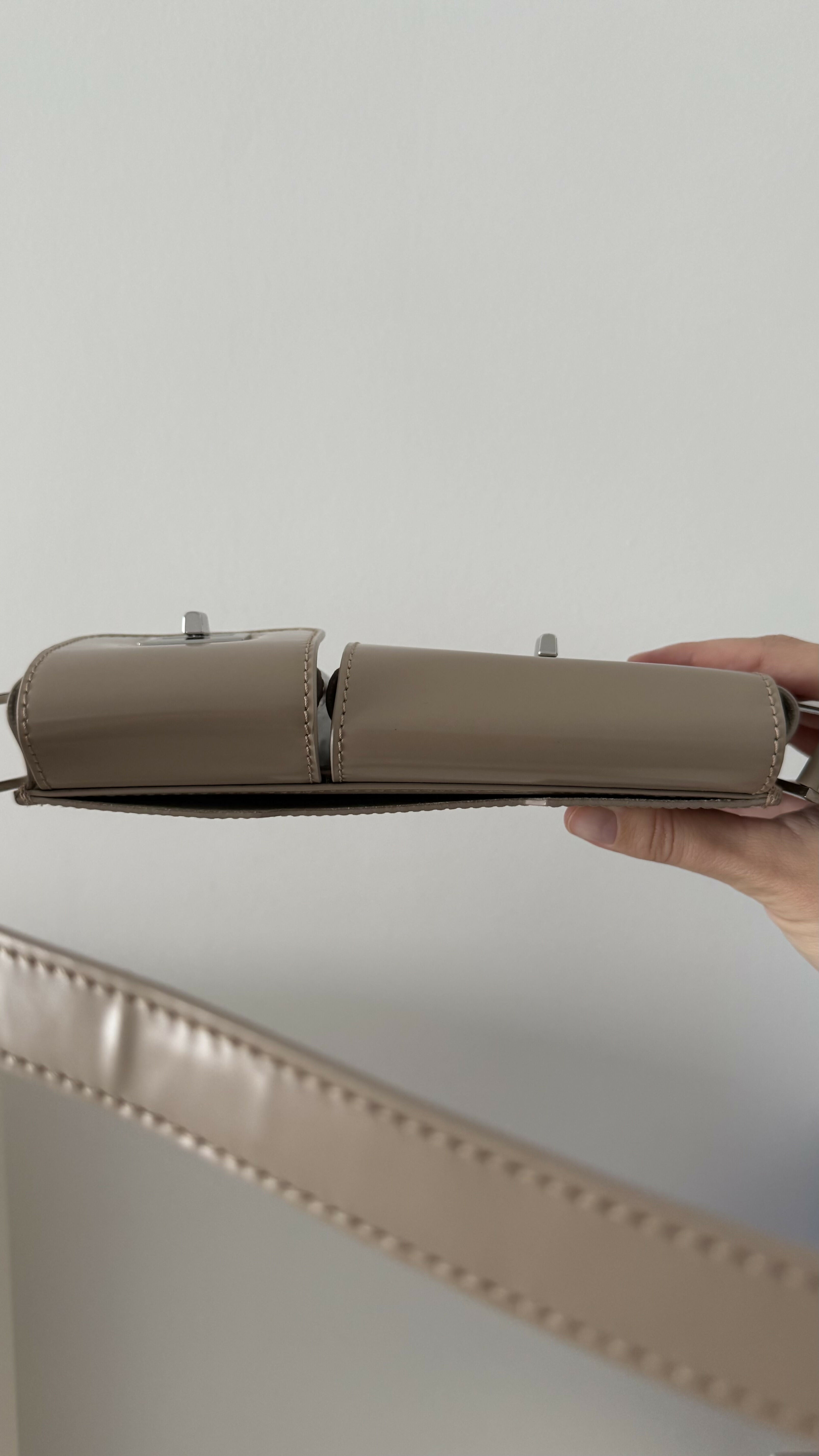 Beige patent leather shoulder bag with dual compartments and silver turnlock closures — Endless | Endless UAE