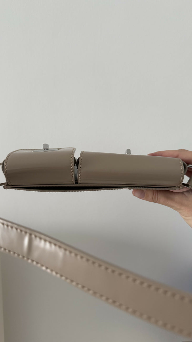 Beige patent leather shoulder bag with dual compartments and silver turnlock closures — Endless | Endless UAE