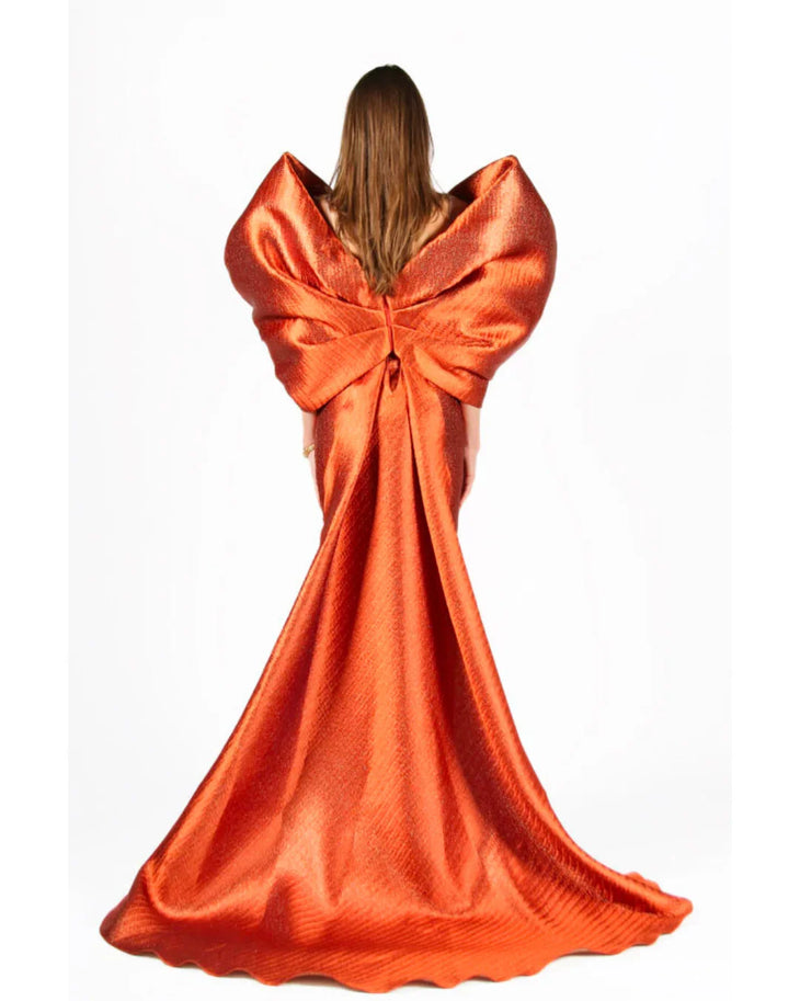 Woman wearing vibrant orange Grace 3D Shoulder Bow gown with dramatic back tail — Anaya Collection | Endless UAE