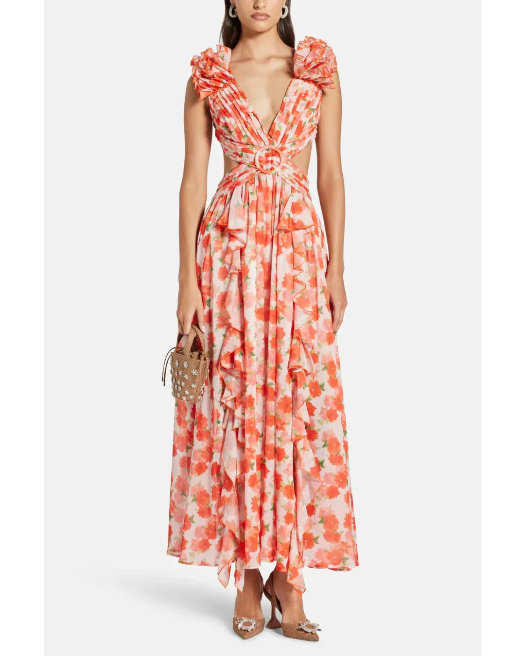 Woman wearing a coral floral maxi dress with flutter sleeves and cutout waist detail — Anne Louise Boutique | Endless UAE