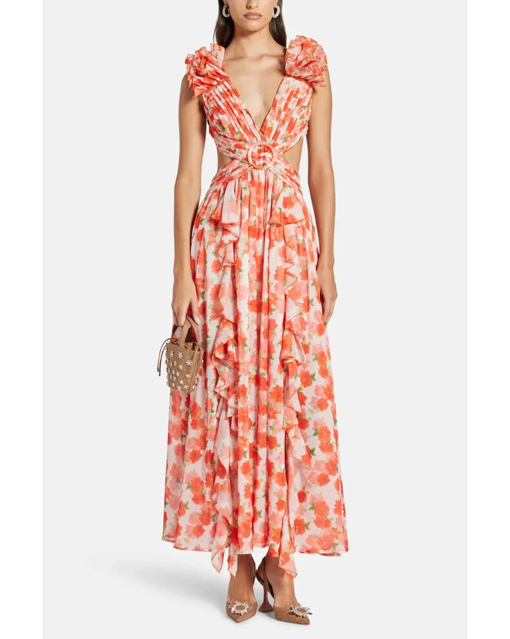 Woman wearing a coral floral maxi dress with flutter sleeves and cutout waist detail — Anne Louise Boutique | Endless UAE