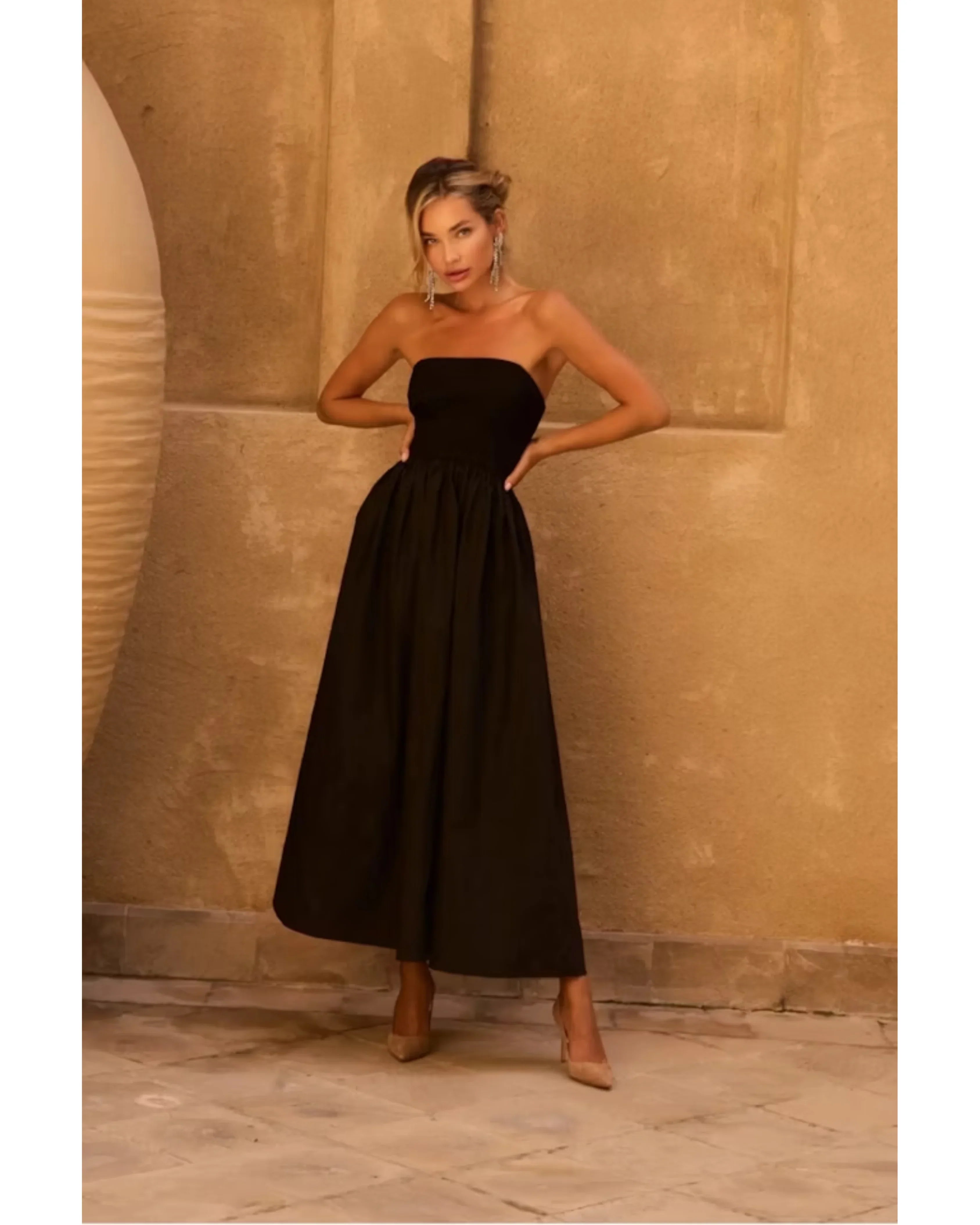 Elegant black strapless midi dress with fitted bodice and flowing skirt, styled with nude heels — Anne Louise Boutique | Endless UAE