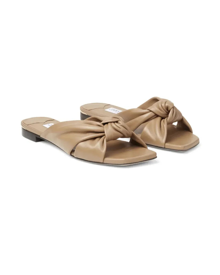 Beige leather flat sandal with twisted knot detail and black sole — Jimmy Choo | Endless UAE