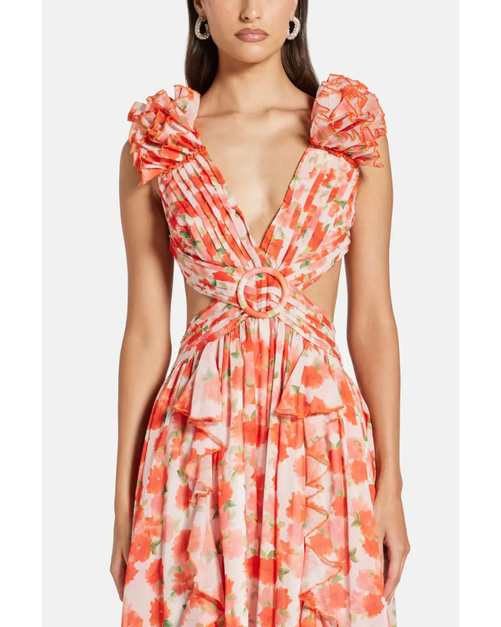 Woman wearing a coral floral maxi dress with flutter sleeves and cutout waist detail — Anne Louise Boutique | Endless UAE