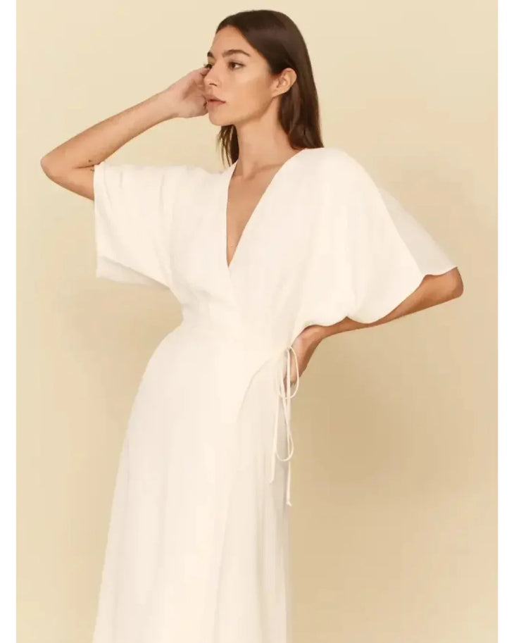 White wrap dress with V-neck and flutter sleeves, featuring side tie detail and midi length — Reformation | Endless UAE