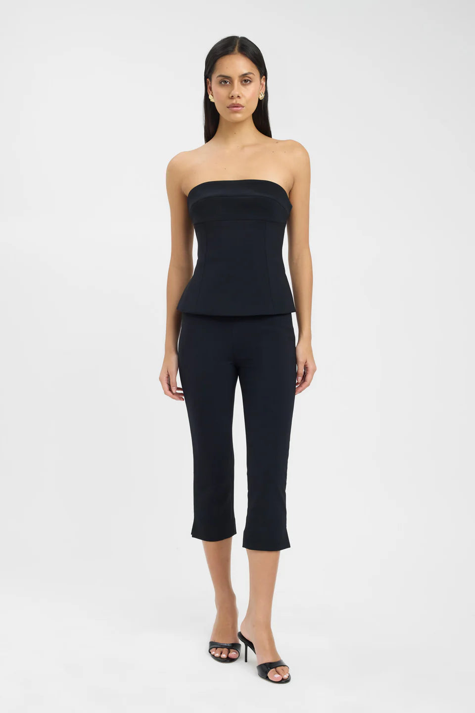 Black strapless peplum top with matching cropped flare pants set on model — Kookai | Endless UAE