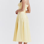 Pale yellow bustier midi dress with ruched bodice and full circle skirt, shown from back — House of CB | Endless UAE
