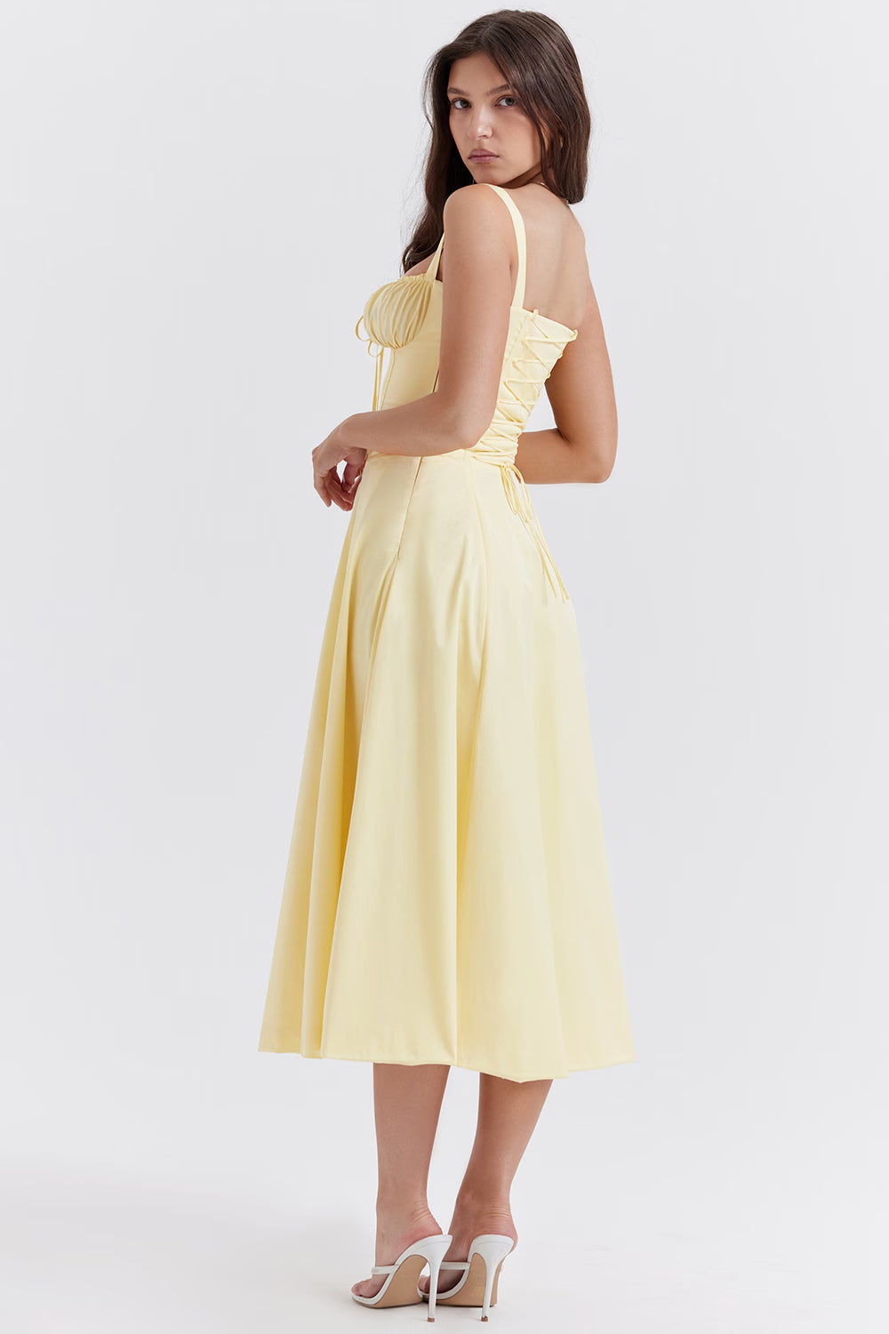 Pale yellow bustier midi dress with ruched bodice and full circle skirt, shown from back — House of CB | Endless UAE