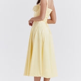 Pale yellow bustier midi dress with ruched bodice and full circle skirt, shown from back — House of CB | Endless UAE