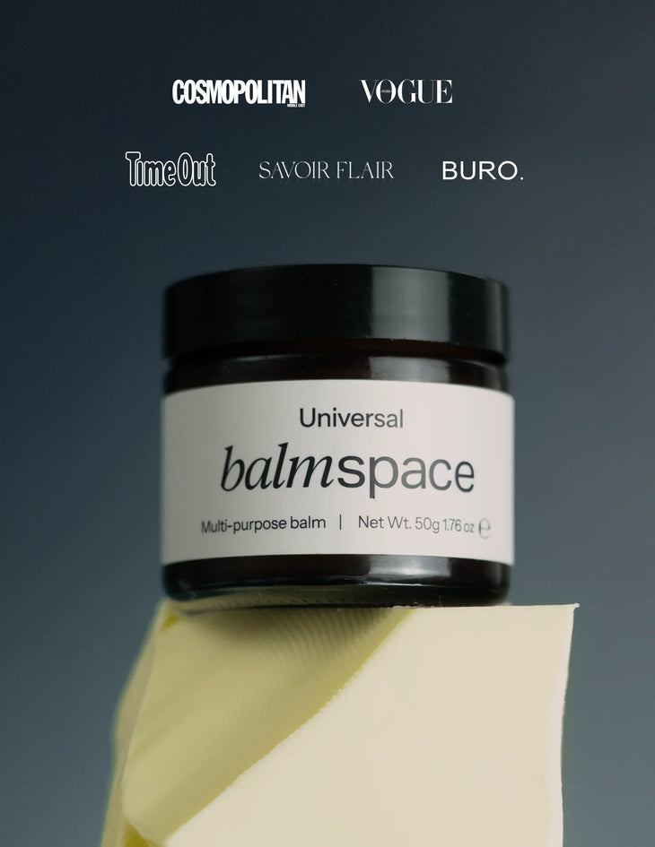 Dark amber glass jar of Balm Space Universal multi-purpose balm with minimalist cream label, positioned on geometric yellow surface — Balm Space | Endless UAE