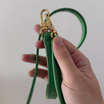 Green crocodile-embossed mini tote bag with gold hardware held by hand — By Far | Endless UAE