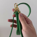 Green crocodile-embossed mini tote bag with gold hardware held by hand — By Far | Endless UAE