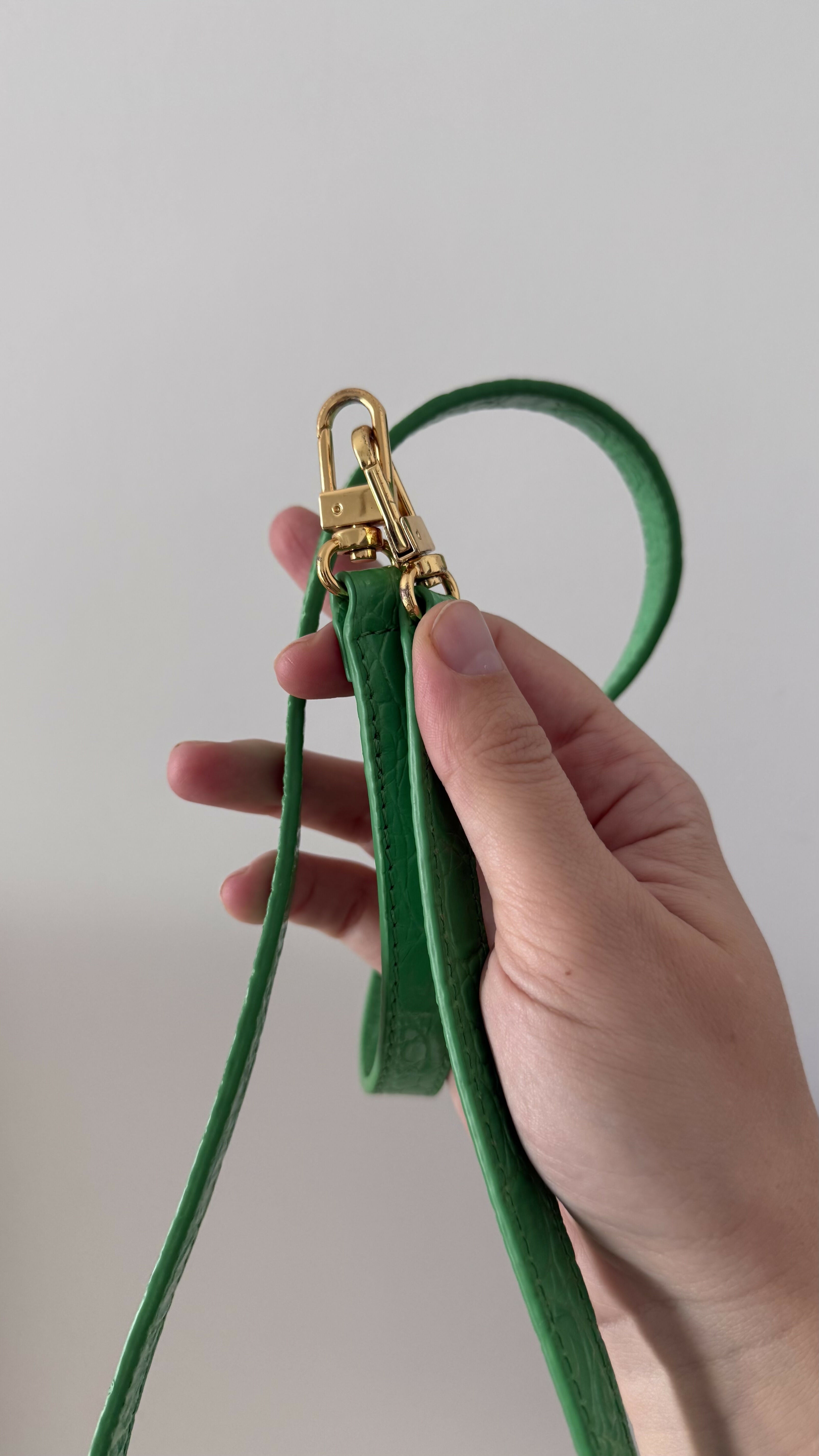 Green crocodile-embossed mini tote bag with gold hardware held by hand — By Far | Endless UAE