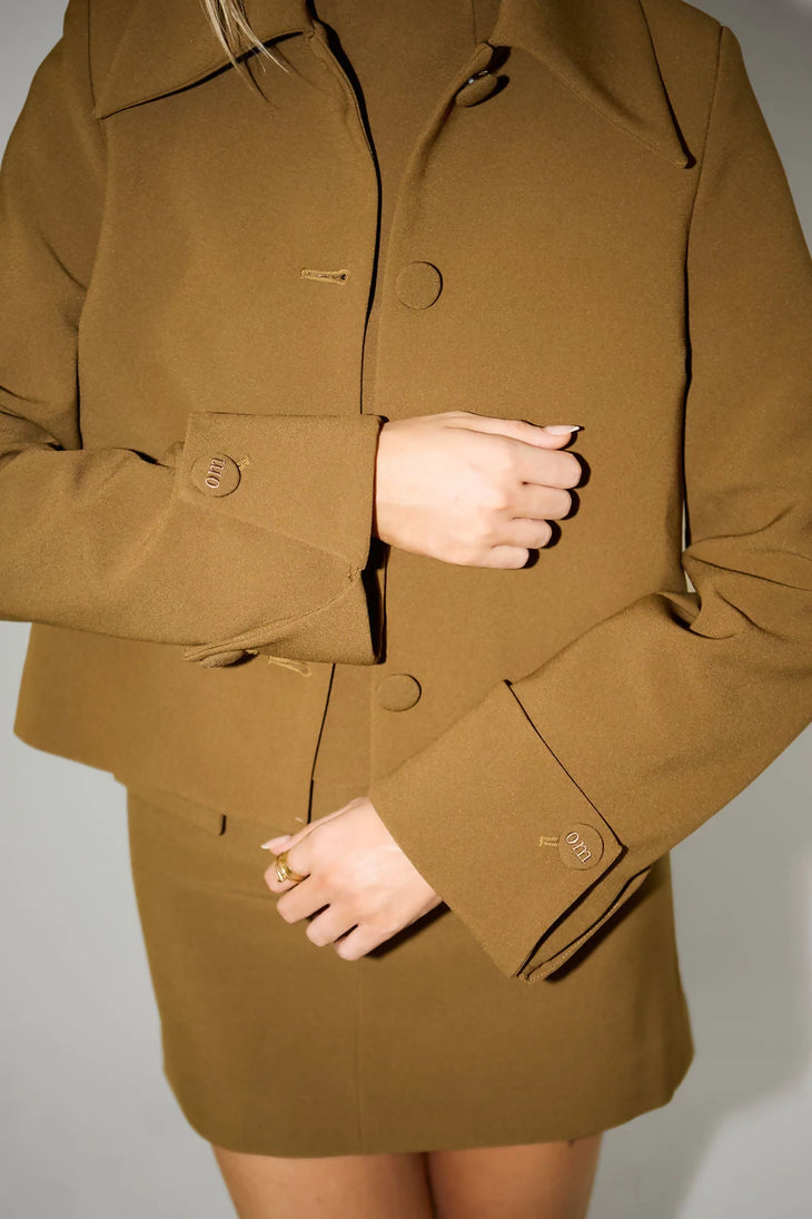 Olive structured blazer jacket with gold button details and matching mini skirt worn by model — Odd Muse | Endless UAE