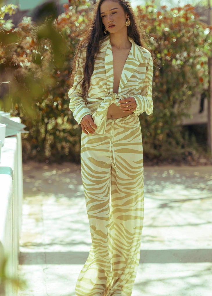 Zebra print trousers in cream and tan worn with matching blazer — Dvete | Endless UAE
