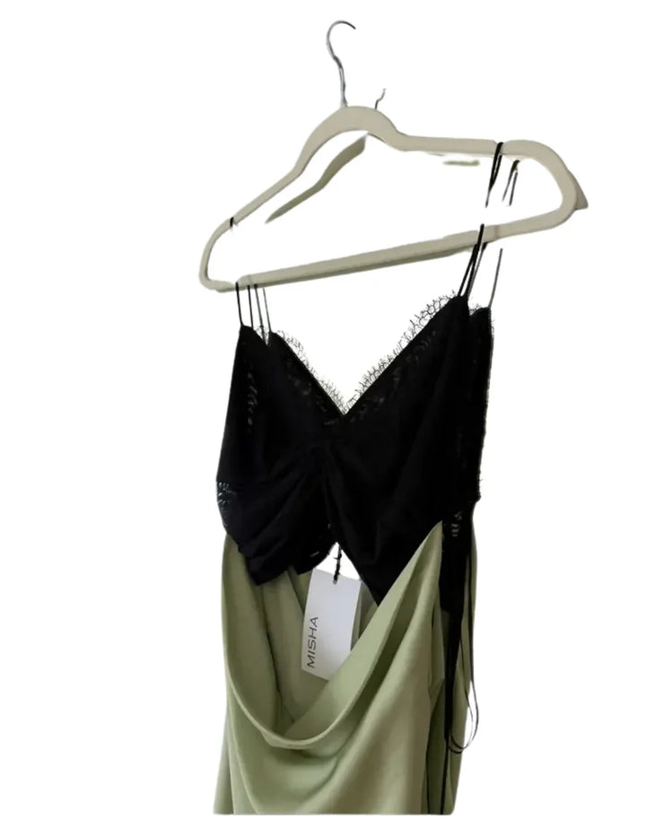Woman wearing black and sage green color-block satin maxi dress with cutout detail — Misha | Endless UAE