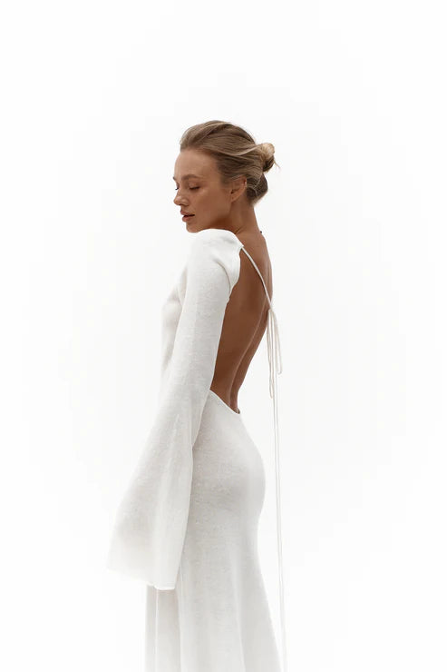 Elegant white knit maxi dress with open back design and long sleeves, perfect for sophisticated occasions — Affluence | Endless UAE