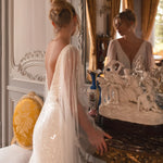 Embellished mermaid wedding dress with flowing cape and plunging neckline — Katy Corso Glen | Endless UAE